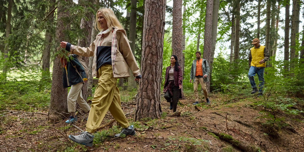 Group of people hiking through a forest in Orthofeet shoes.